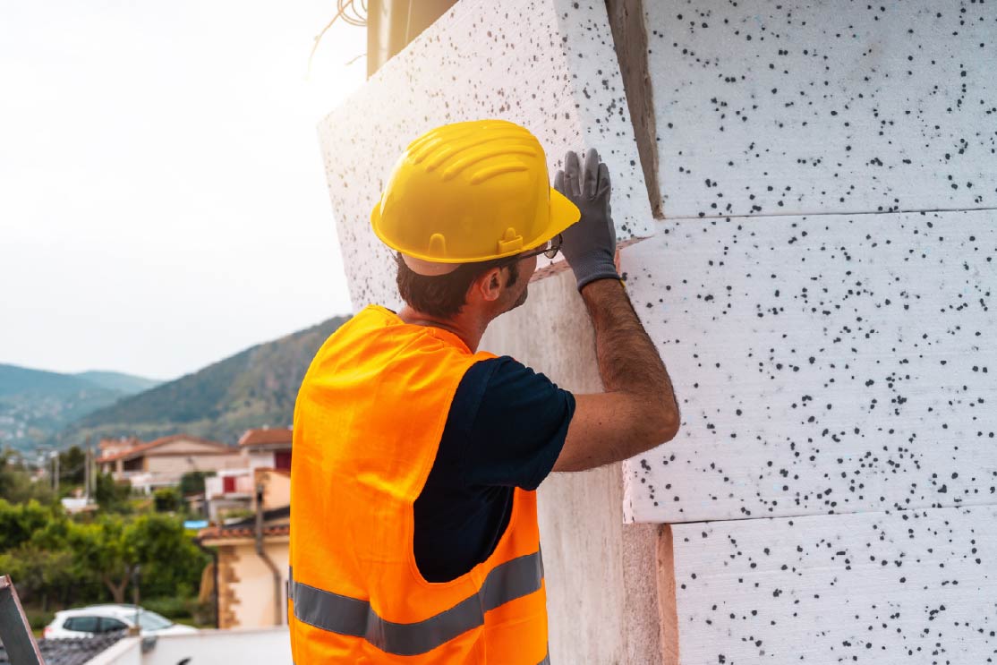 construction worker installing siding
