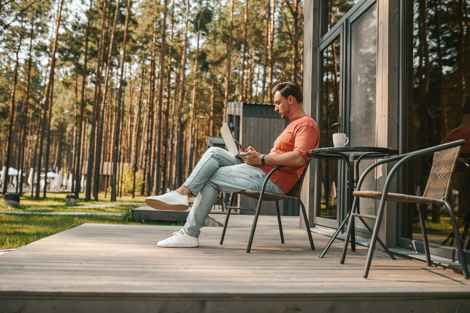 work from home young man with laptop sitting outside working online